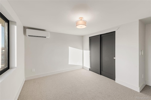 unfurnished bedroom with a closet, a wall mounted AC, and light carpet