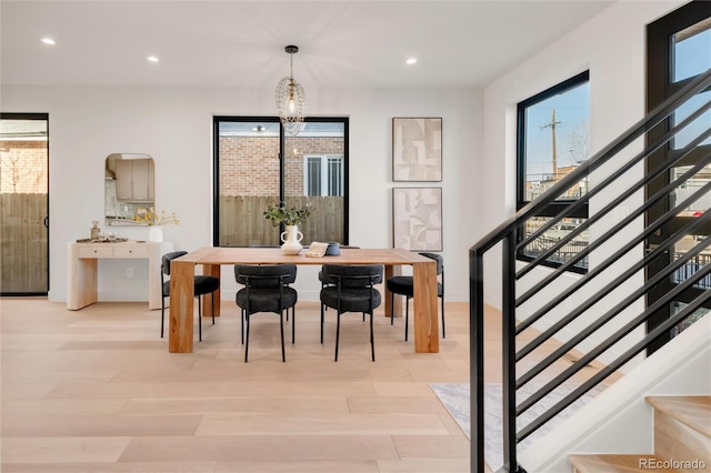 dining room featuring an inviting chandelier and light hardwood / wood-style flooring