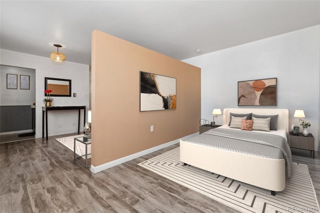 bedroom with dark hardwood / wood-style flooring