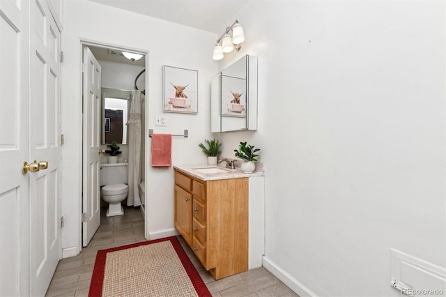 bathroom featuring vanity and toilet