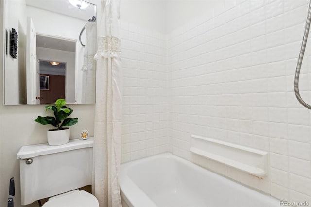 bathroom with shower / bath combination with curtain and toilet