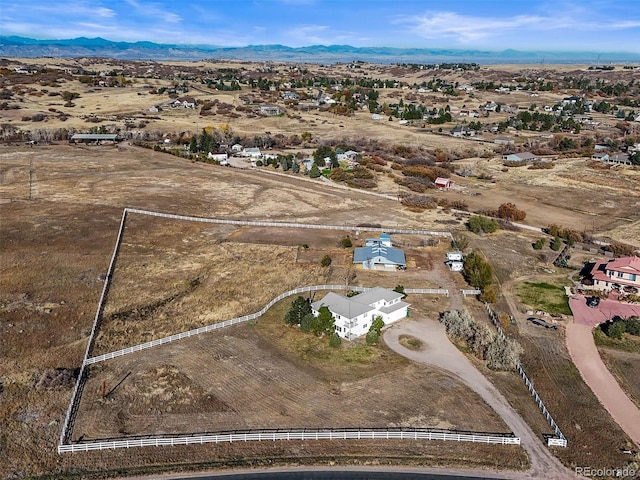 drone / aerial view featuring a mountain view and a rural view