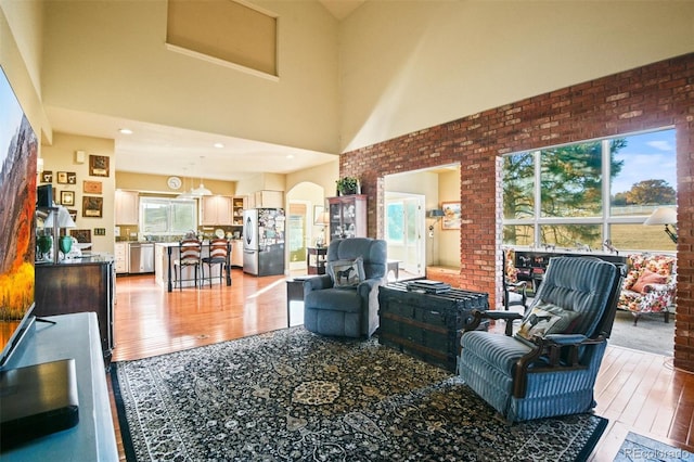 living room with a high ceiling and hardwood / wood-style floors