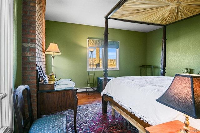 bedroom with hardwood / wood-style flooring and a baseboard radiator