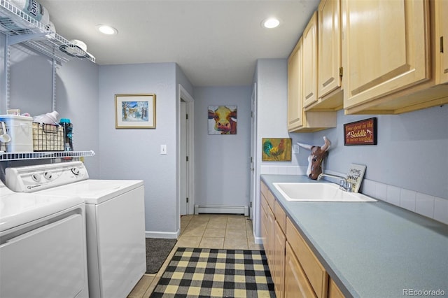 washroom featuring separate washer and dryer, sink, cabinets, light tile patterned floors, and baseboard heating