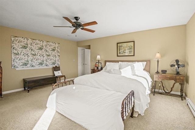 carpeted bedroom featuring a baseboard radiator and ceiling fan