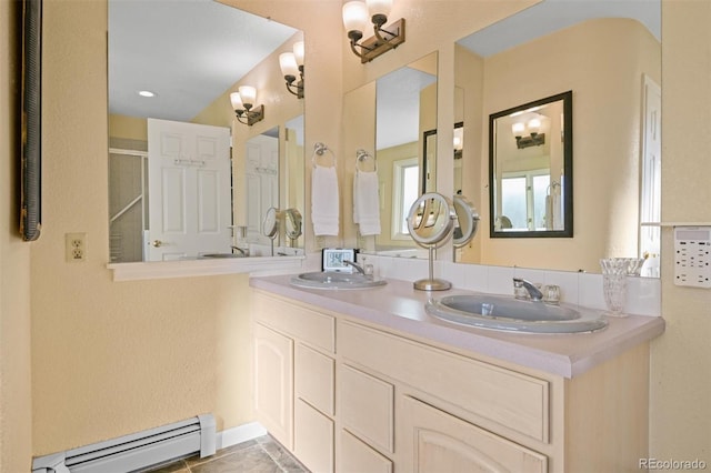 bathroom with vanity, walk in shower, tile patterned floors, and baseboard heating