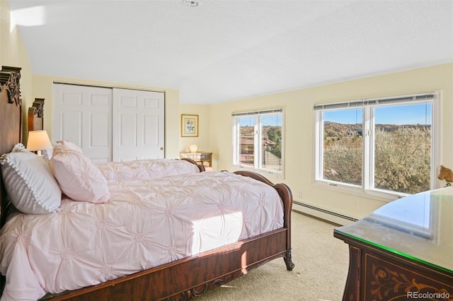 carpeted bedroom featuring a baseboard radiator and a closet