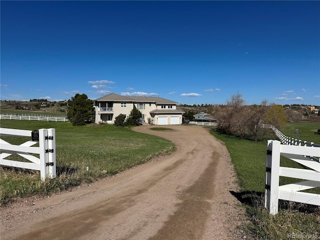 595 W Oak Hill Ln, Castle Rock, CO 80108 - traditional home with driveway, a view of countryside, and an attached garage