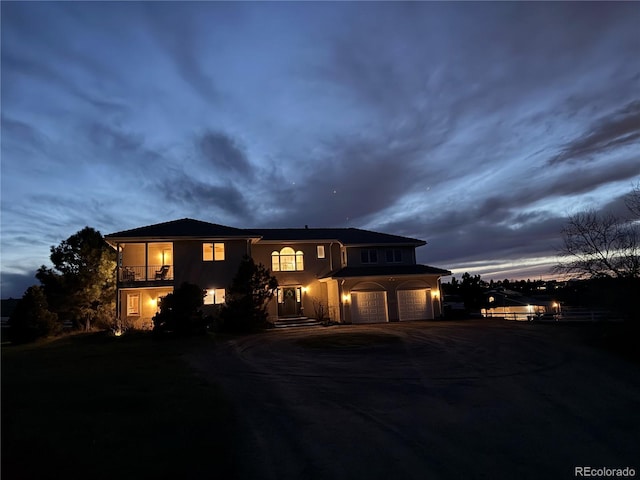 595 W Oak Hill Ln, Castle Rock, CO 80108 - view of front of property featuring a garage, driveway, stucco siding, and a balcony
