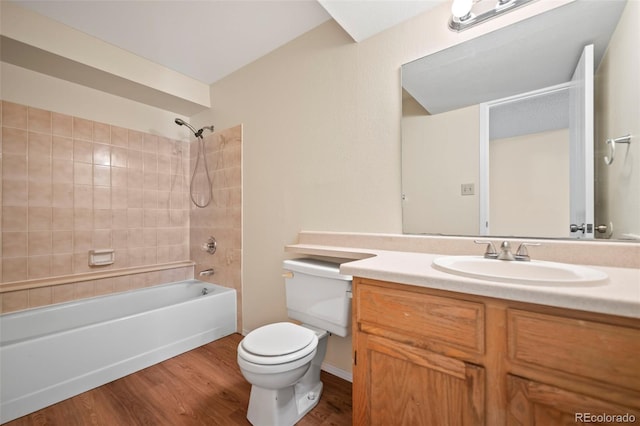 bathroom with toilet, wood finished floors, vanity, and bathing tub / shower combination
