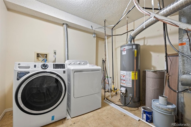 laundry room featuring gas water heater, washing machine and dryer, laundry area, and a textured ceiling