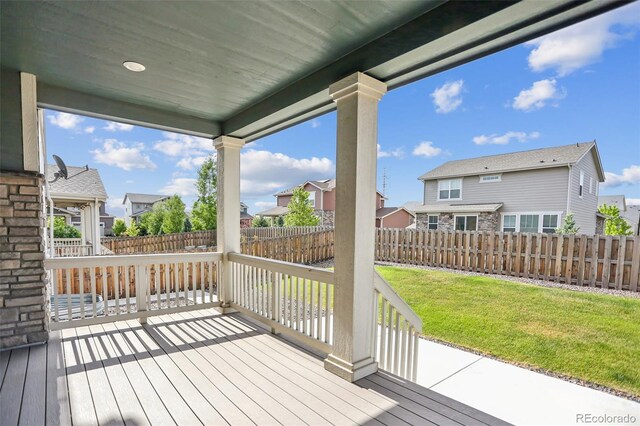 wooden terrace with a lawn