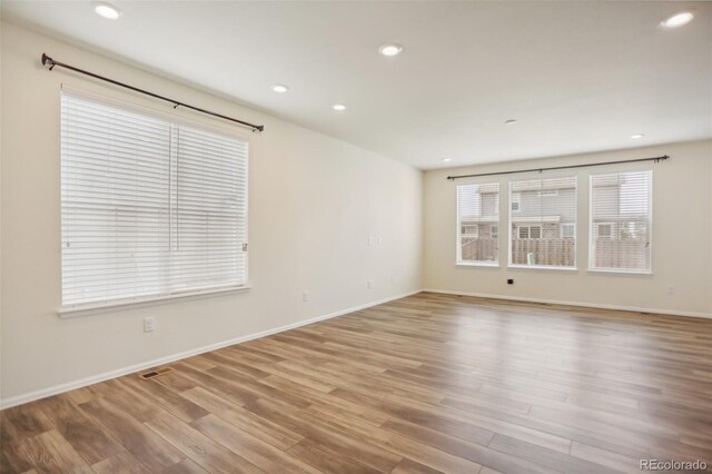 spare room with light hardwood / wood-style flooring