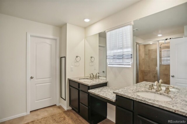 bathroom featuring walk in shower and vanity