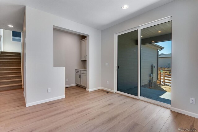 unfurnished room featuring light hardwood / wood-style flooring and a wealth of natural light