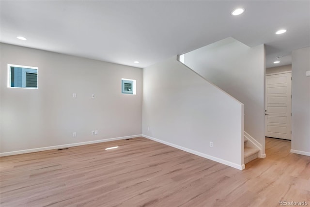 basement with light hardwood / wood-style flooring