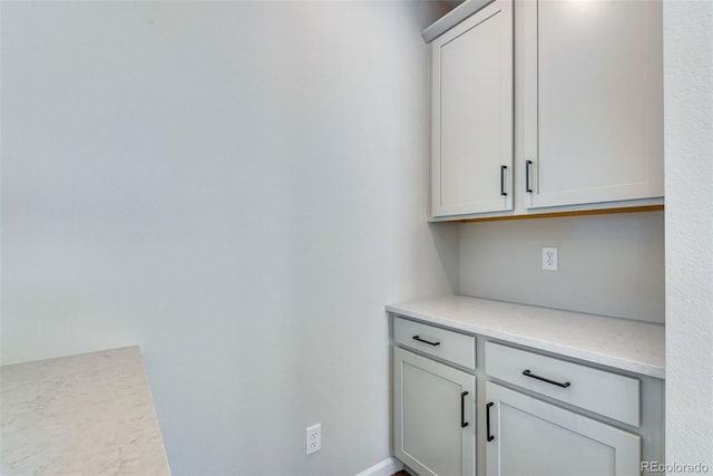 bar featuring light stone countertops