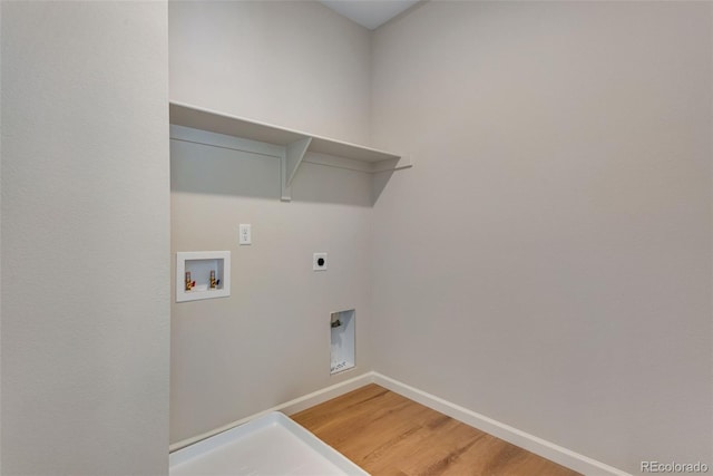 washroom with hookup for an electric dryer, hookup for a washing machine, and hardwood / wood-style floors