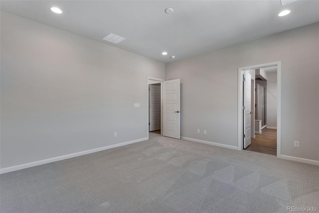 unfurnished bedroom featuring light carpet