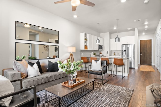 living room featuring dark wood finished floors, recessed lighting, a ceiling fan, and visible vents