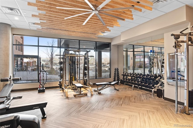 workout area with visible vents and a paneled ceiling