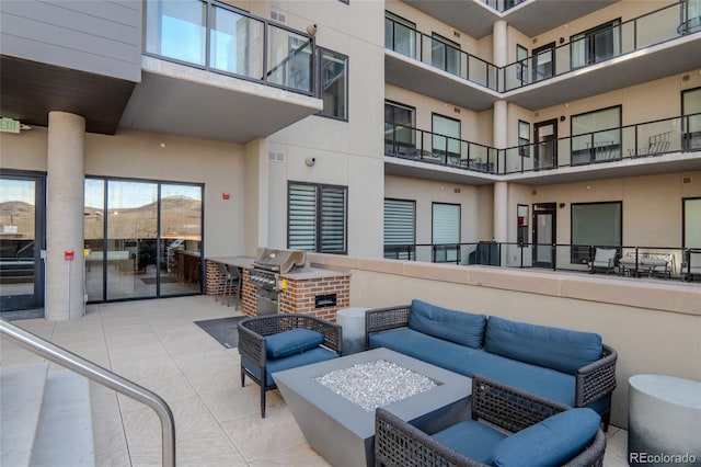 view of patio / terrace featuring area for grilling, visible vents, an outdoor living space with a fire pit, and grilling area