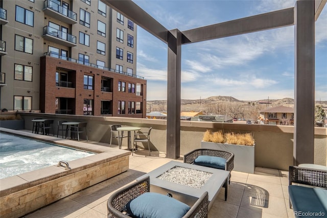 view of patio featuring a mountain view and an outdoor fire pit