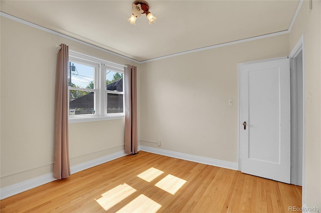 1208 S Elizabeth St, Denver, CO 80210 - empty room featuring light wood-style floors, baseboards, and crown molding