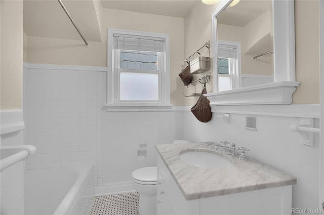 1208 S Elizabeth St, Denver, CO 80210 - full bathroom featuring vanity, a tub to relax in, and toilet
