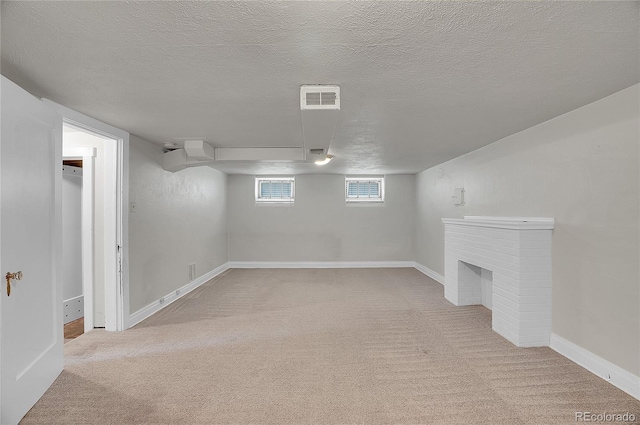 1208 S Elizabeth St, Denver, CO 80210 - below grade area featuring carpet floors, a textured ceiling, baseboards, and a fireplace