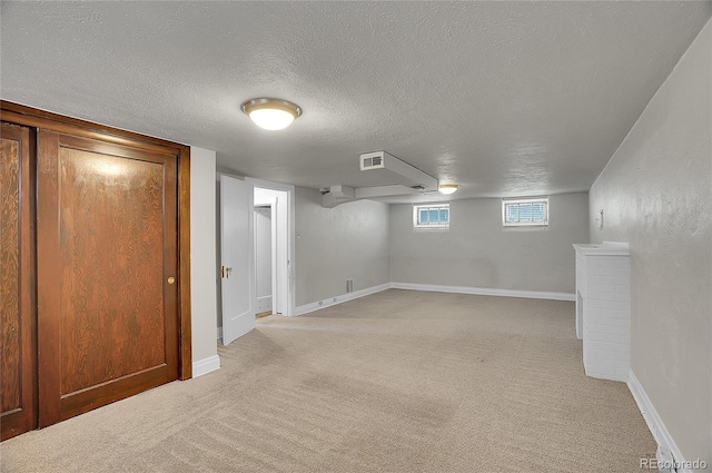 1208 S Elizabeth St, Denver, CO 80210 - below grade area with light colored carpet, a textured ceiling, and baseboards
