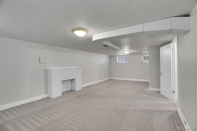 1208 S Elizabeth St, Denver, CO 80210 - below grade area with light carpet, a textured ceiling, a fireplace, and baseboards