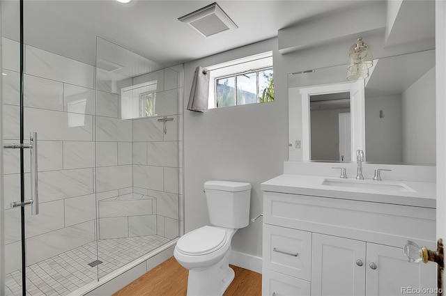 1208 S Elizabeth St, Denver, CO 80210 - bathroom featuring toilet, a stall shower, vanity, and wood finished floors