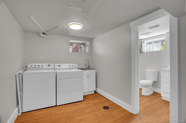 1208 S Elizabeth St, Denver, CO 80210 - washroom with washing machine and clothes dryer, light wood-type flooring, and baseboards