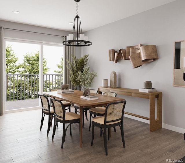 dining space featuring an inviting chandelier, wood finished floors, baseboards, and recessed lighting