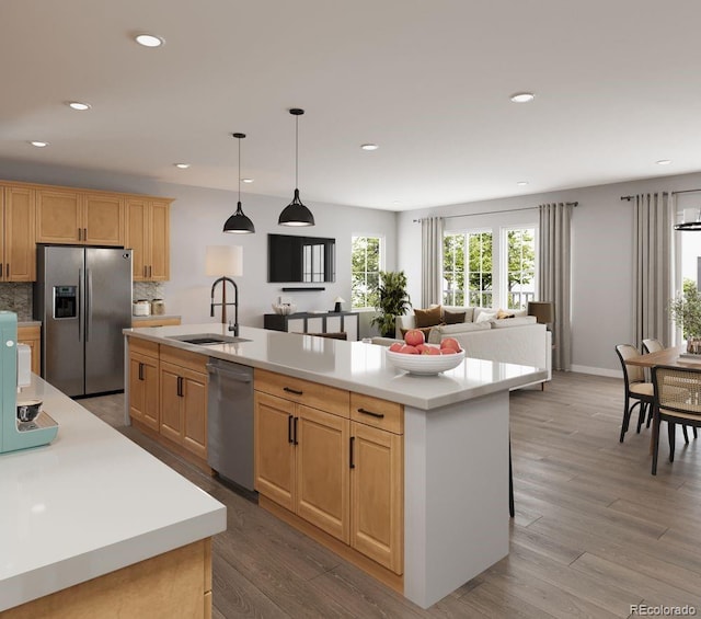 kitchen featuring a sink, recessed lighting, light countertops, light brown cabinets, and appliances with stainless steel finishes