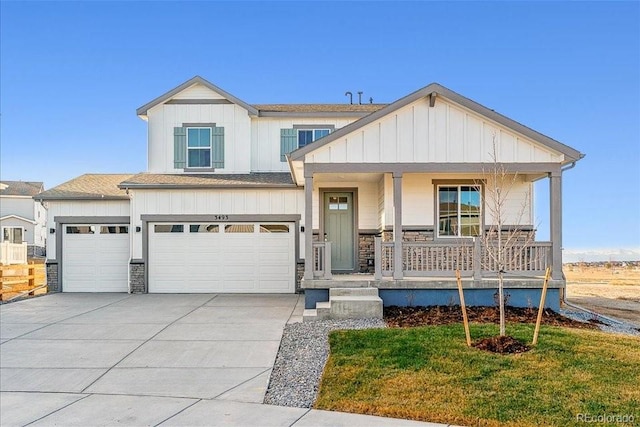 view of front of home featuring a garage, covered porch, and a front lawn