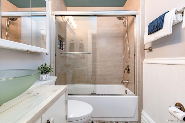 2358 N Ogden St Unit B, Denver, CO 80205 - bathroom featuring vanity, combined bath / shower with glass door, and a wainscoted wall