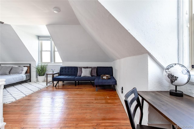 2358 N Ogden St Unit B, Denver, CO 80205 - living area with hardwood / wood-style floors, lofted ceiling, and a textured wall