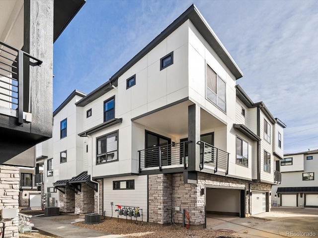 2050 S Holly St Unit 1, Denver, CO 80222 - view of property featuring an attached garage and driveway