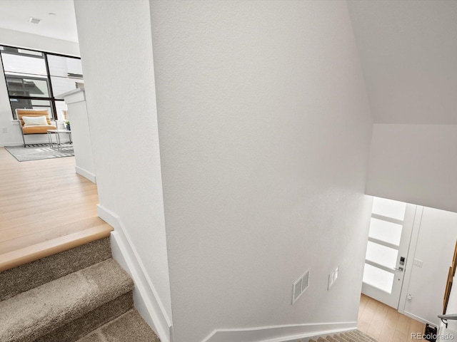 2050 S Holly St Unit 1, Denver, CO 80222 - stairs featuring wood finished floors and baseboards