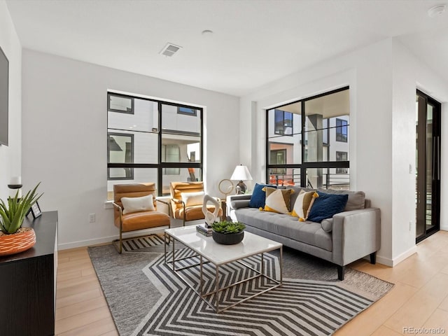 2050 S Holly St Unit 1, Denver, CO 80222 - living area featuring light wood-style floors and baseboards