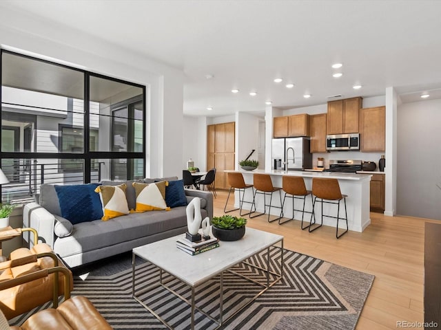 2050 S Holly St Unit 1, Denver, CO 80222 - living room with light wood finished floors and recessed lighting