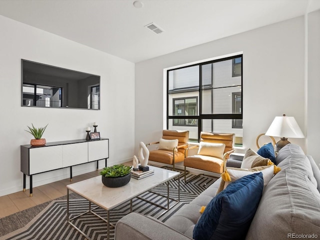 2050 S Holly St Unit 1, Denver, CO 80222 - living room featuring wood finished floors and baseboards
