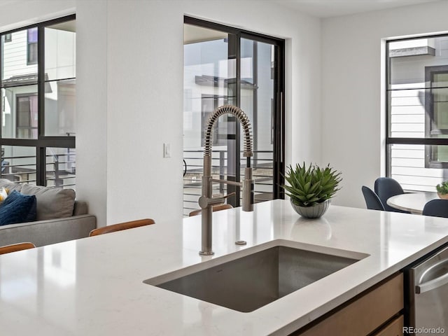2050 S Holly St Unit 1, Denver, CO 80222 - kitchen view of dishwasher and light stone countertops