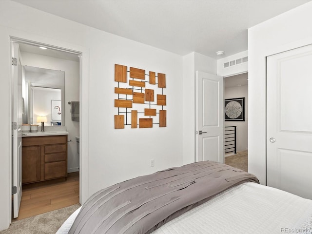 2050 S Holly St Unit 1, Denver, CO 80222 - bedroom with light carpet and ensuite bath