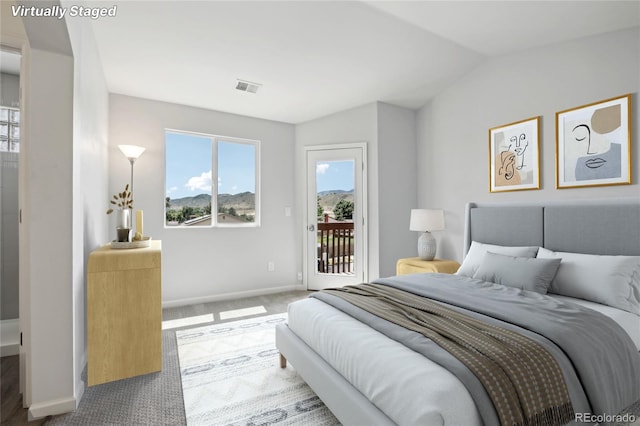 carpeted bedroom featuring access to outside, visible vents, vaulted ceiling, and baseboards