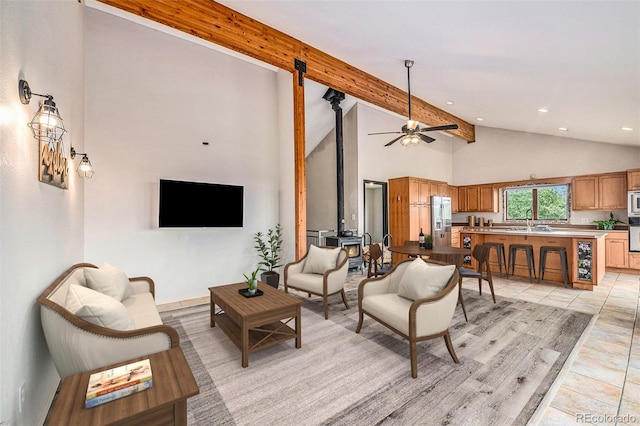 tiled living room featuring high vaulted ceiling, ceiling fan, beamed ceiling, and sink