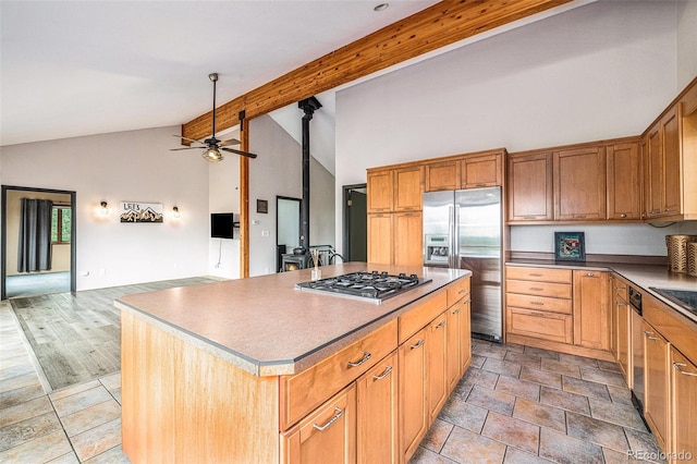 kitchen with a center island, ceiling fan, lofted ceiling with beams, hardwood / wood-style flooring, and appliances with stainless steel finishes